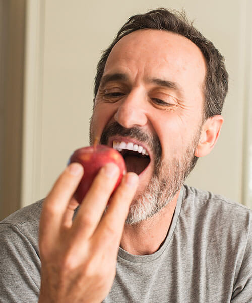 A man about to eat an apple