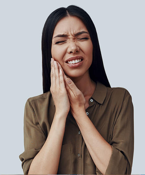 A woman holding her jaw in pain