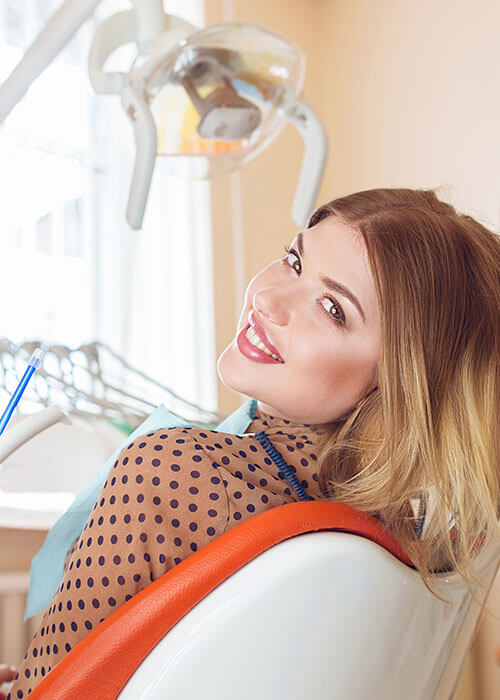 Woman looking over her shoulder while in the dental chair