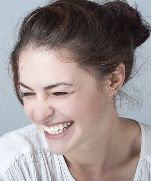 Woman on a gray background smiling