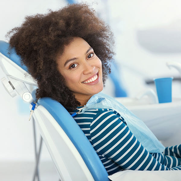 Blonde woman smiling in the dentist chair